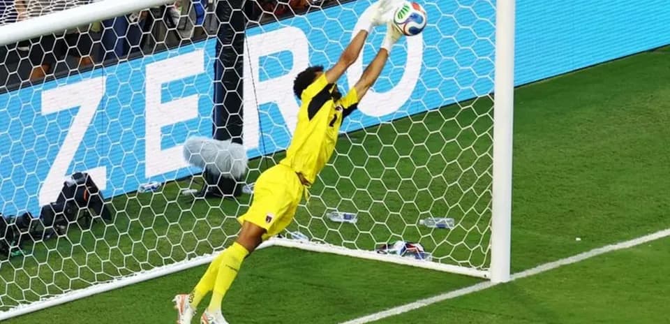 Goalkeeper diving to make a save during match