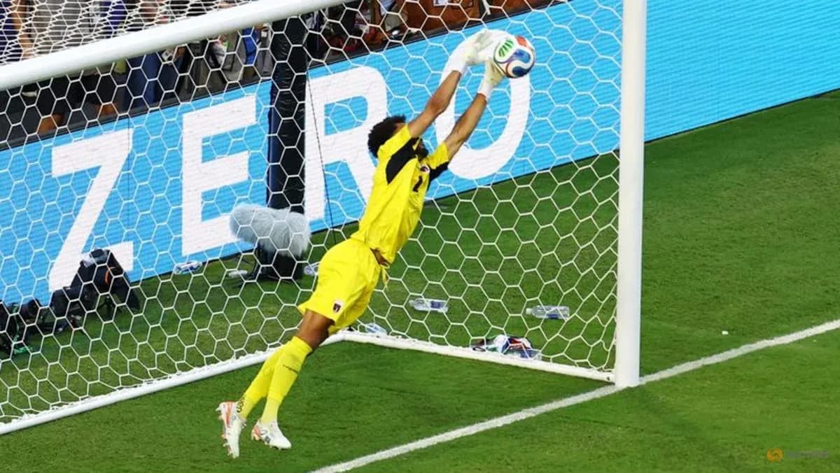 Goalkeeper diving to make a save during match
