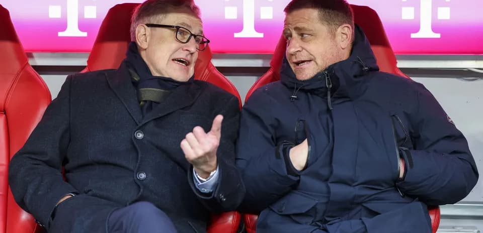 Two men seated on bench discussing during match