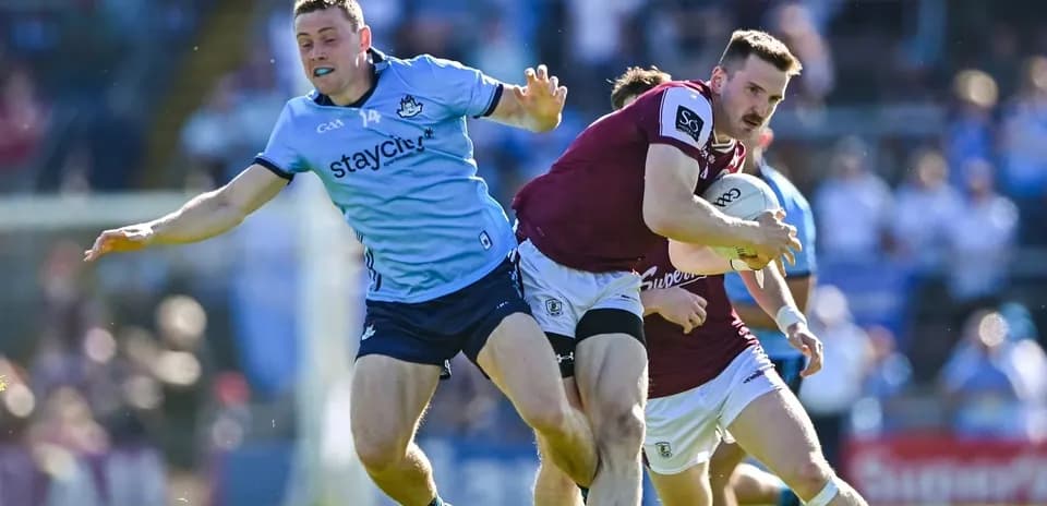 Player being tackled while carrying the ball