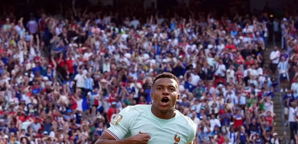 Player celebrating in front of cheering crowd at FIFA World Cup