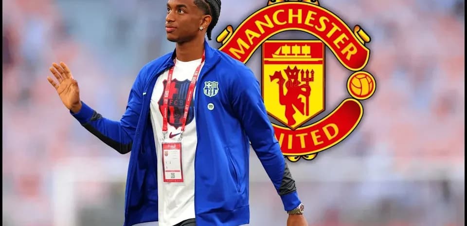 Player walking in front of Manchester United logo