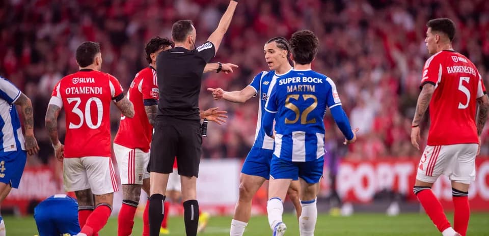 Referee showing yellow card during heated match moment