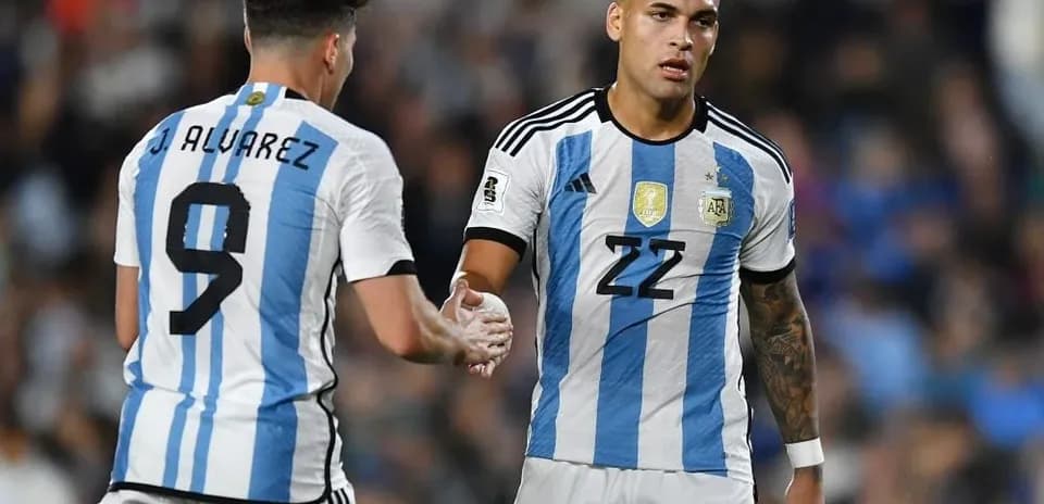 Two Argentina players shaking hands on the field