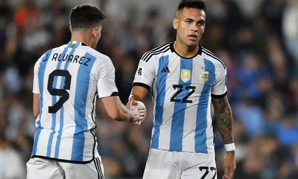 Two Argentina players shaking hands on the field