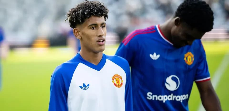 Two Manchester United players warming up on pitch