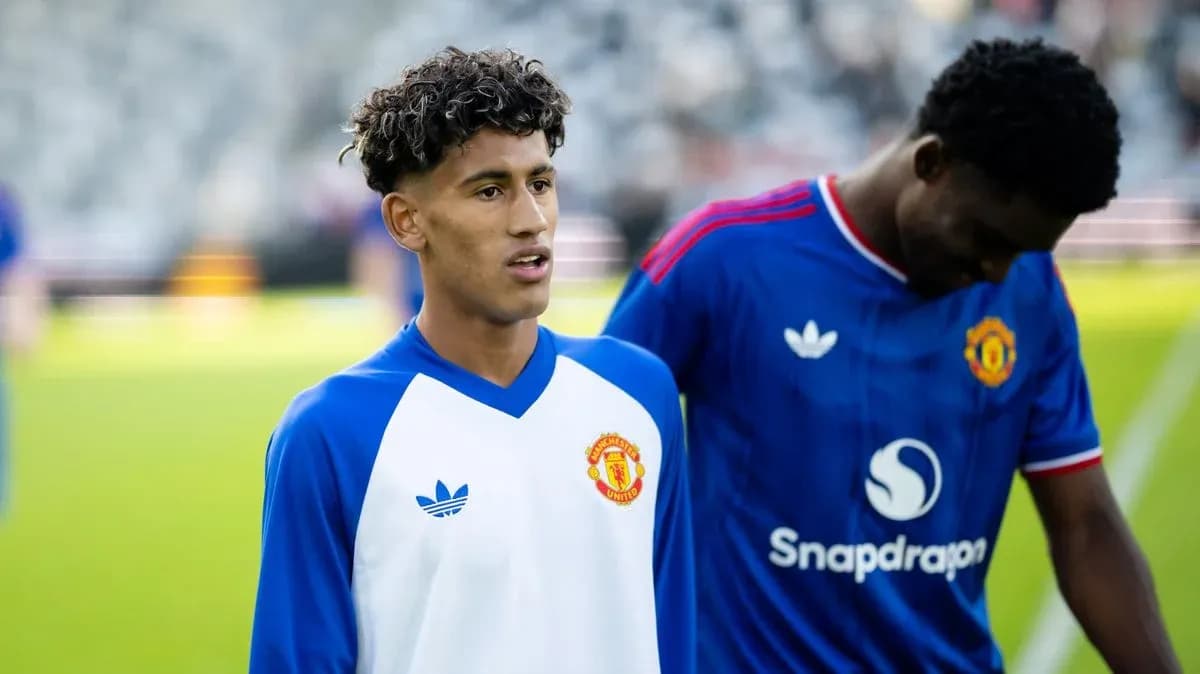 Two Manchester United players warming up on pitch