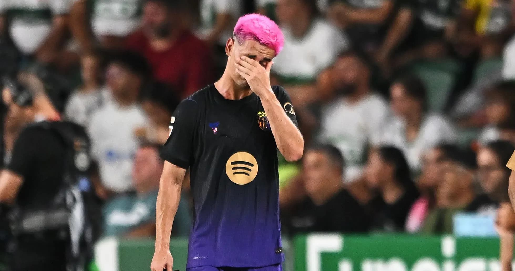 Player with pink hair walking off field during match