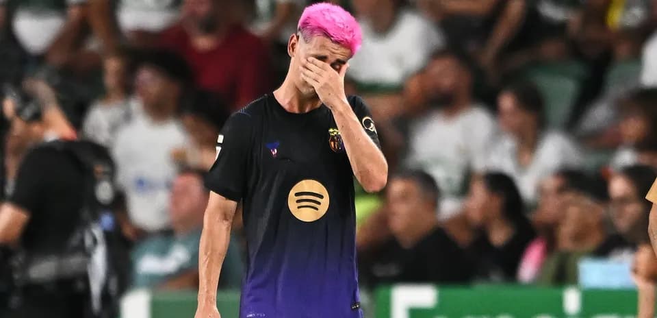 Player with pink hair walking off field during match
