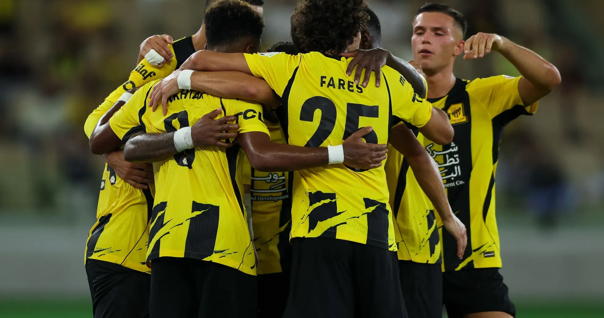 Players celebrating in yellow jerseys after scoring