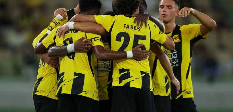 Players celebrating in yellow jerseys after scoring