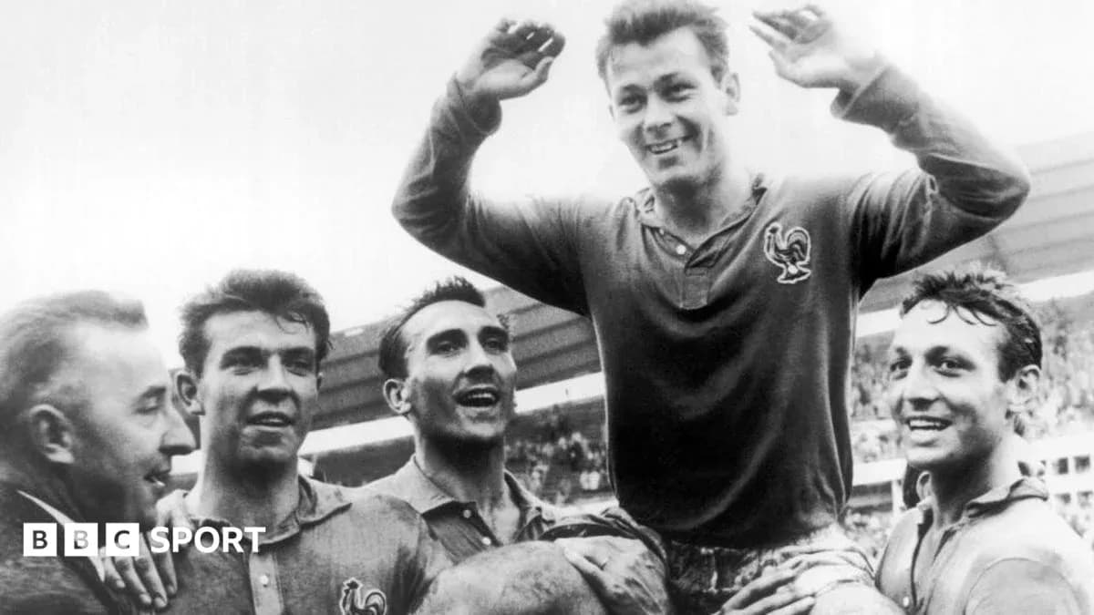 Players celebrating a victory, one lifted in triumph
