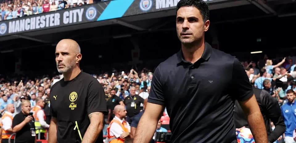 Two coaches walking onto the pitch at stadium