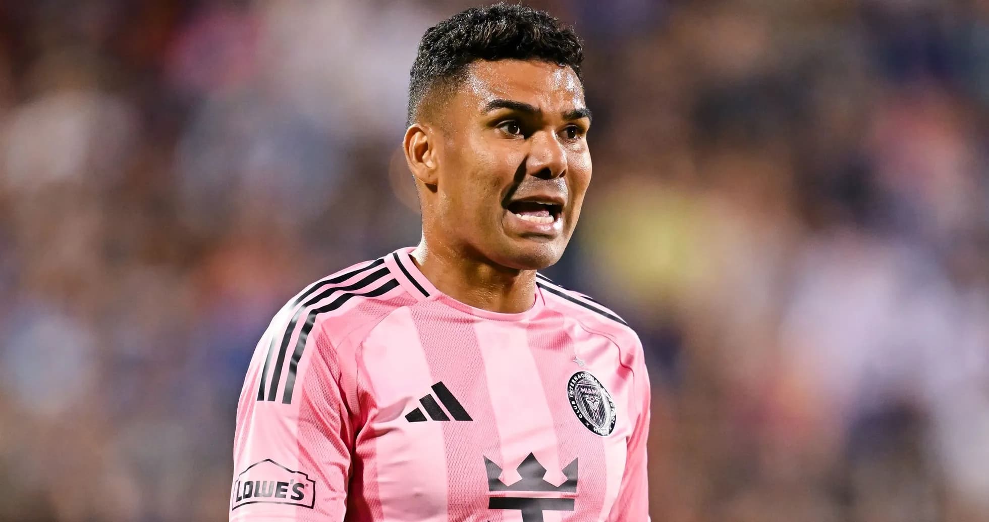 Player in pink jersey speaking during match