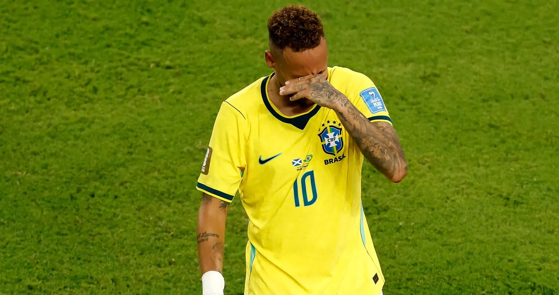 Player in Brazil jersey wiping face after match