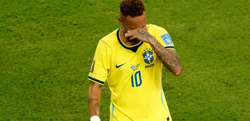 Player in Brazil jersey wiping face after match