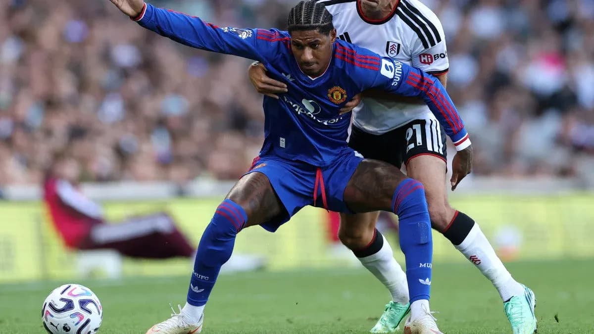 Fulham player tackling Manchester United player