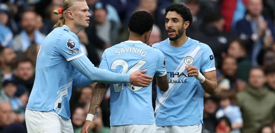 Three Manchester City players discussing during match