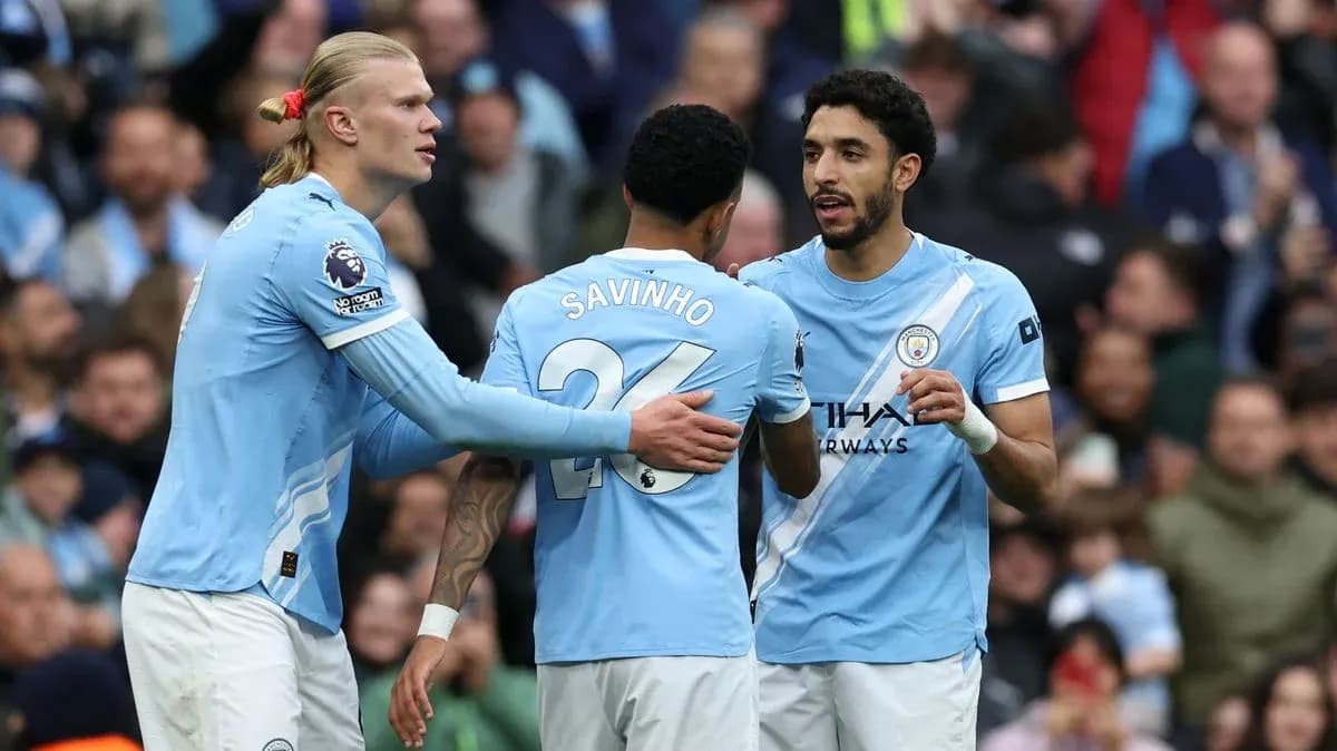 Three Manchester City players discussing during match