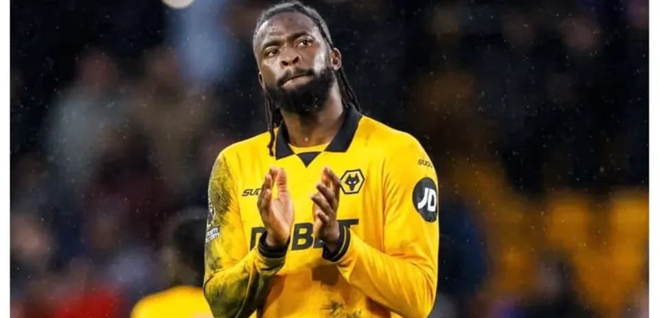 Player in yellow jersey applauding fans after match