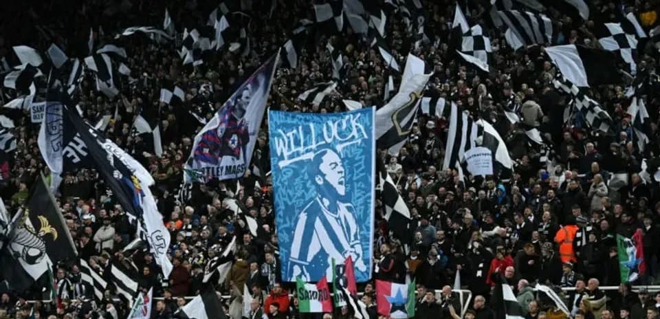 Crowd waving flags during a football match