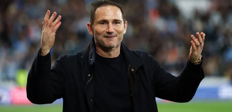 Manager gesturing to fans after match conclusion