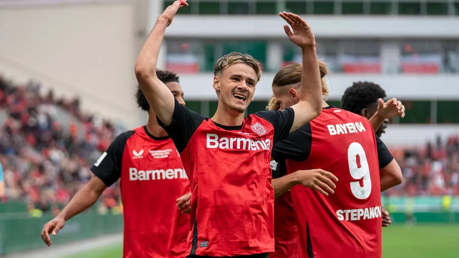 Player celebrating with teammates after scoring goal