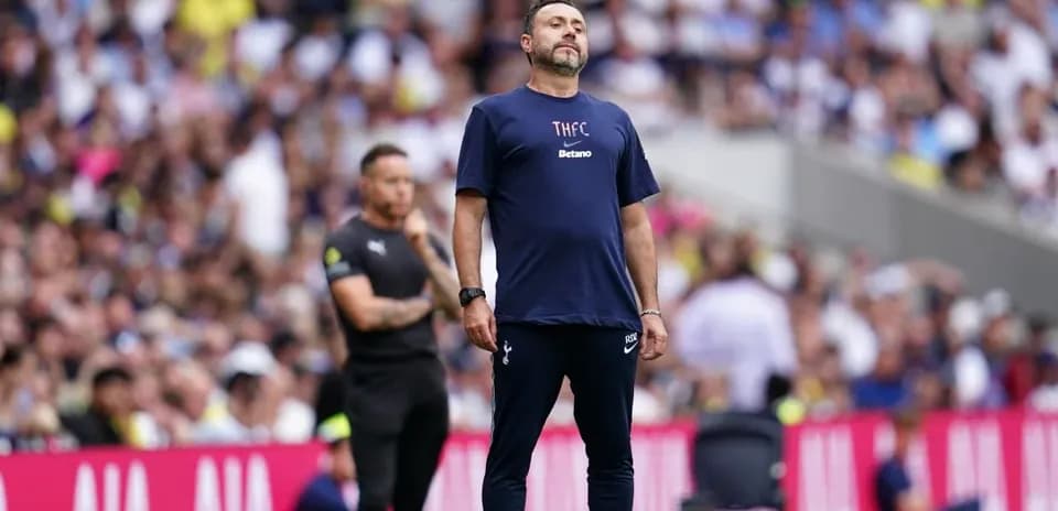Manager observing match on the sidelines with assistant