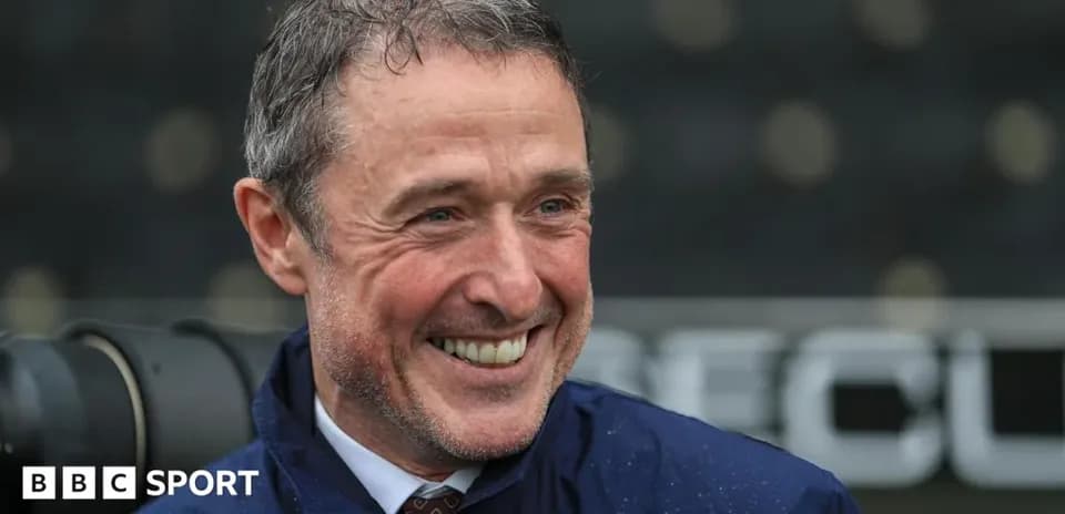 Man smiling during a press conference outdoors
