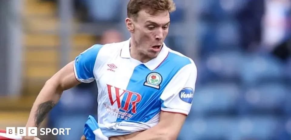 Player in action wearing Blackburn Rovers kit