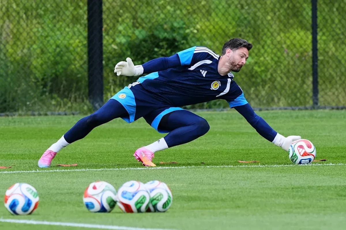 Goalkeeper diving to catch a soccer ball during training