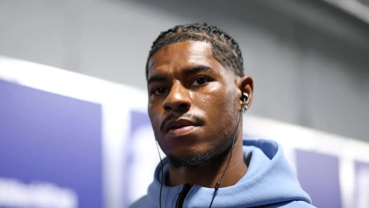 Athlete wearing headphones in a hallway