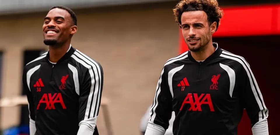 Two Liverpool players walking during training session