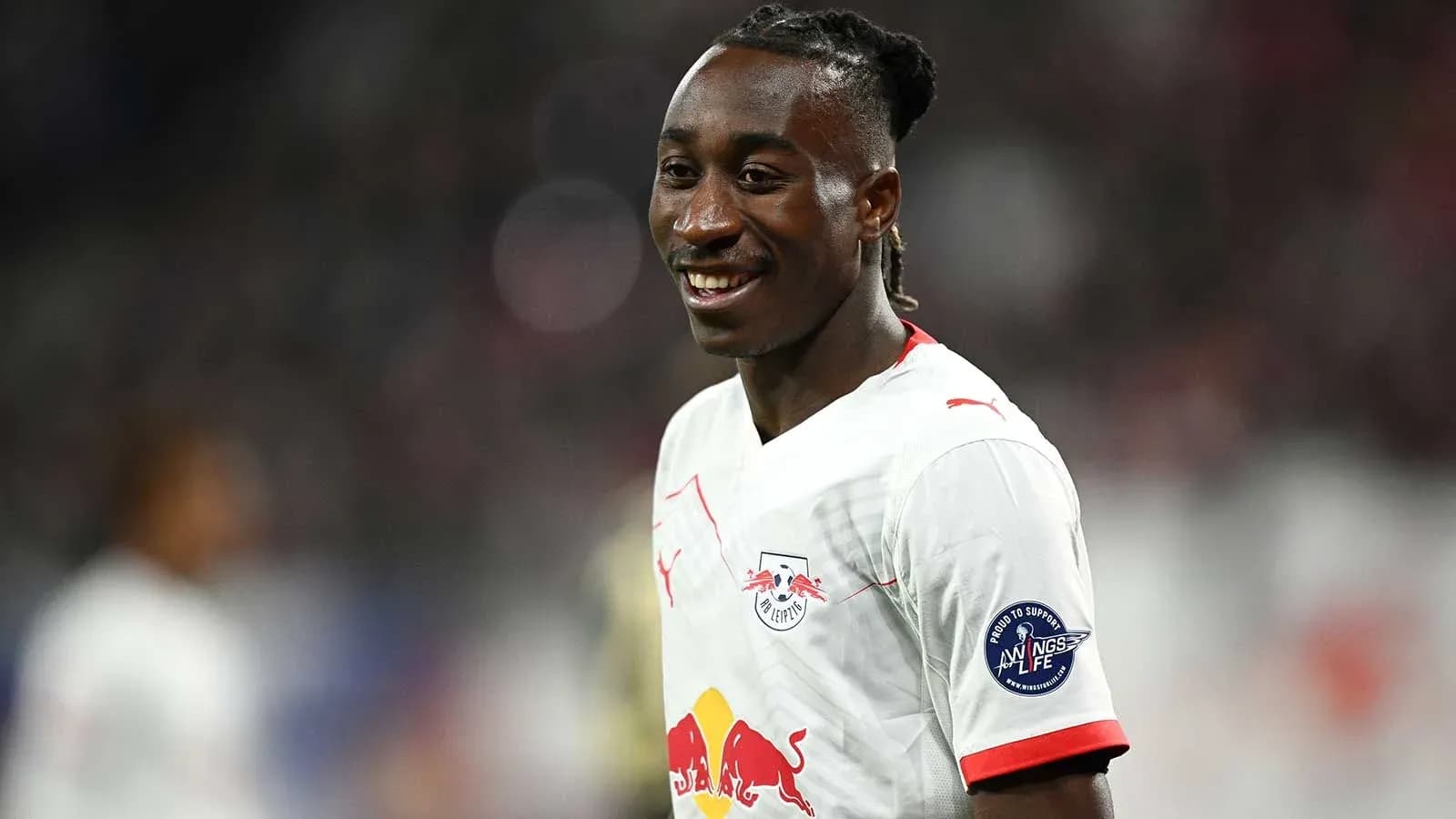 Player smiling in RB Leipzig jersey during match