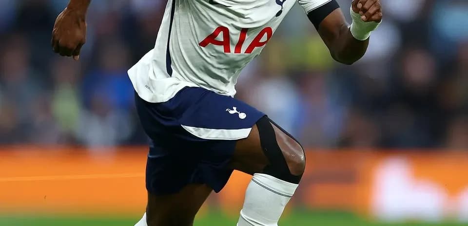 Player sprinting on field during match for Tottenham