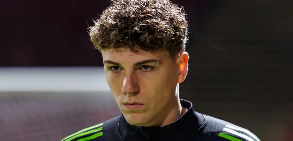Goalkeeper preparing for match with focused expression