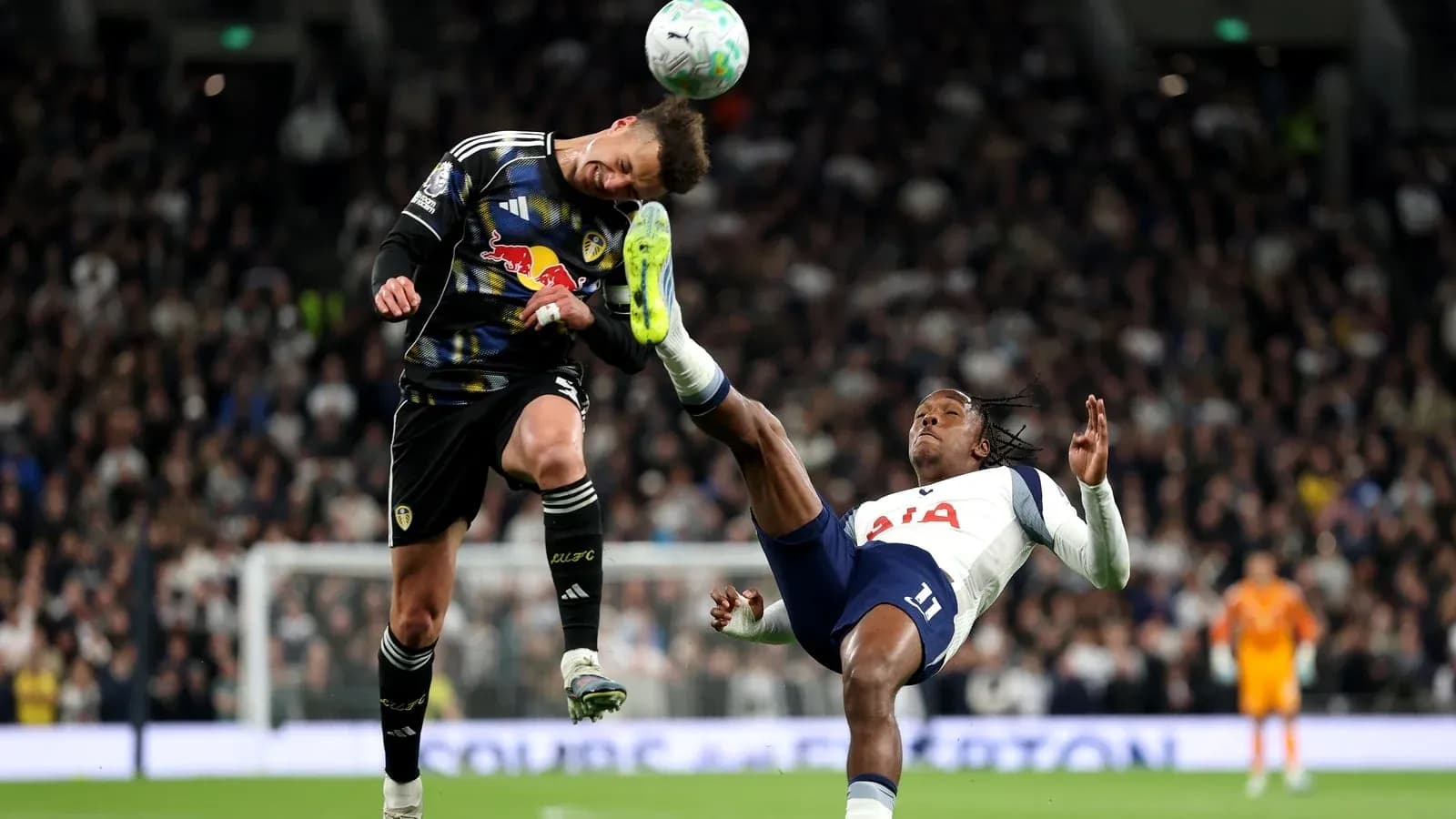 Goalkeeper and player colliding during a match