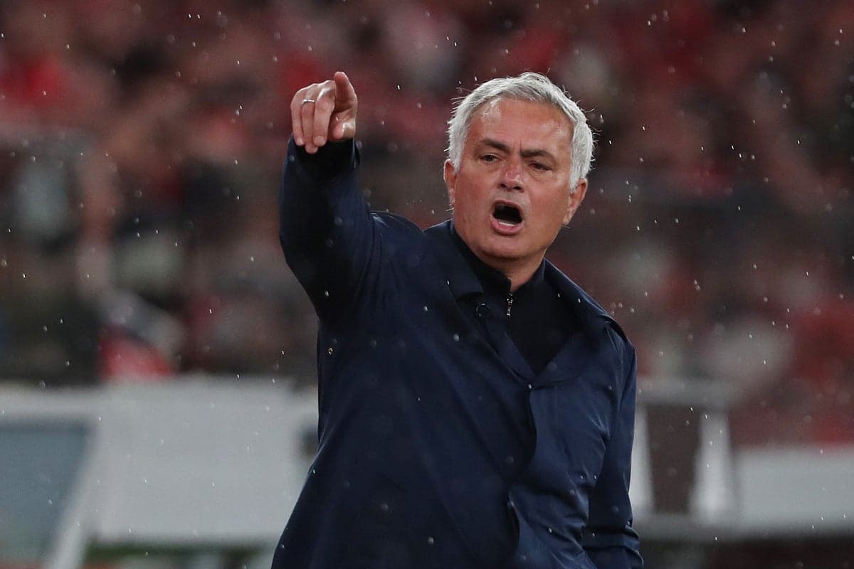 Coach directing players during a rainy match