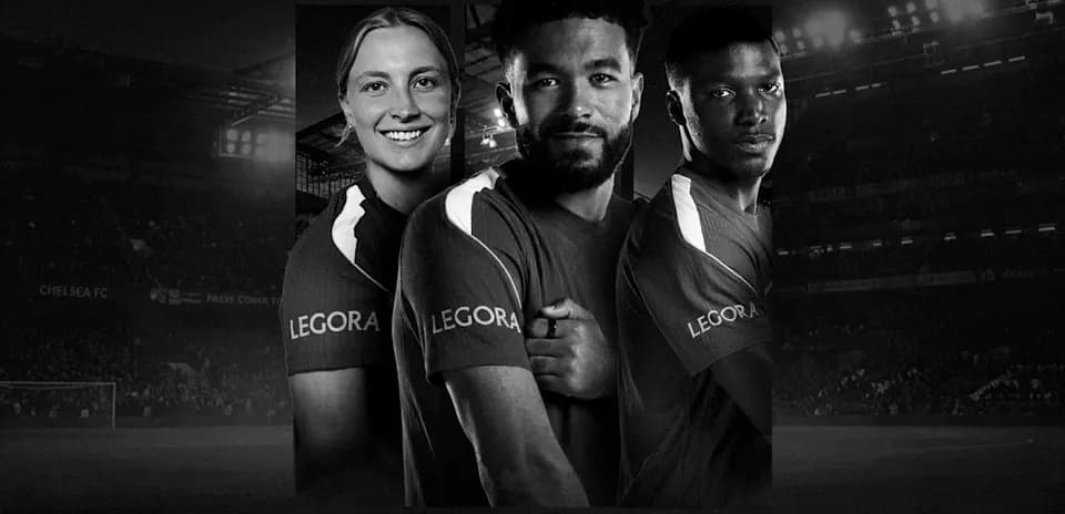 Three soccer players posing in team jerseys