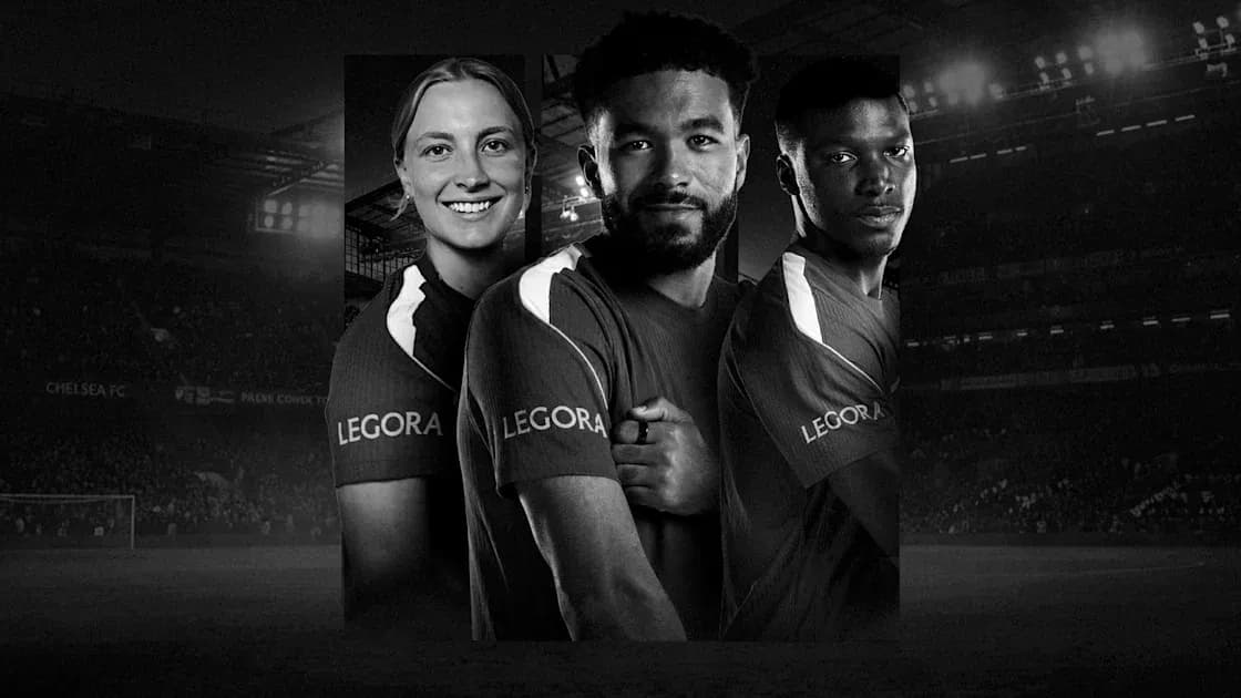Three soccer players posing in team jerseys