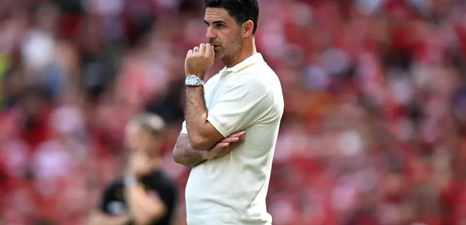 Manager observing match with thoughtful expression