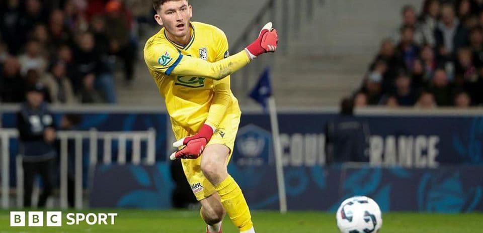 Goalkeeper in yellow kit playing the ball