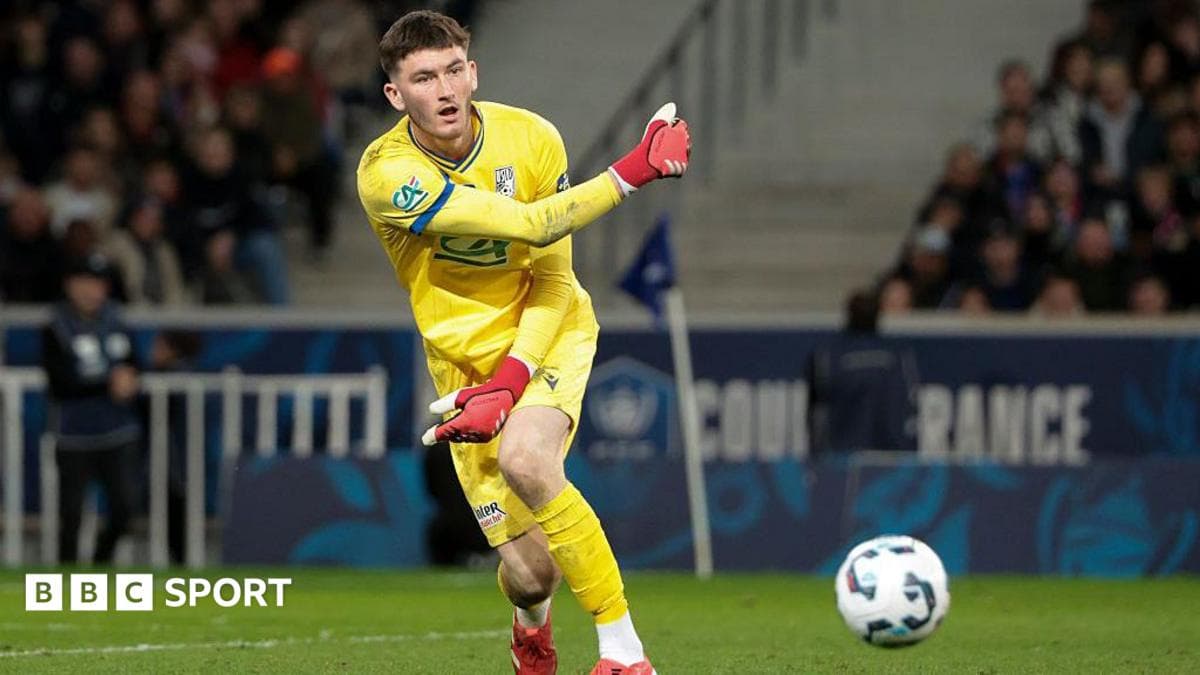 Goalkeeper in yellow kit playing the ball
