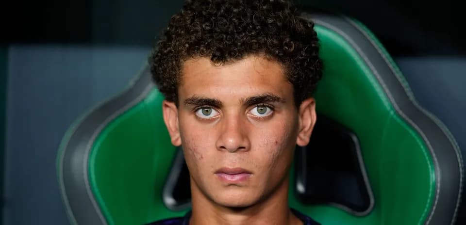Young athlete sitting on green gaming chair