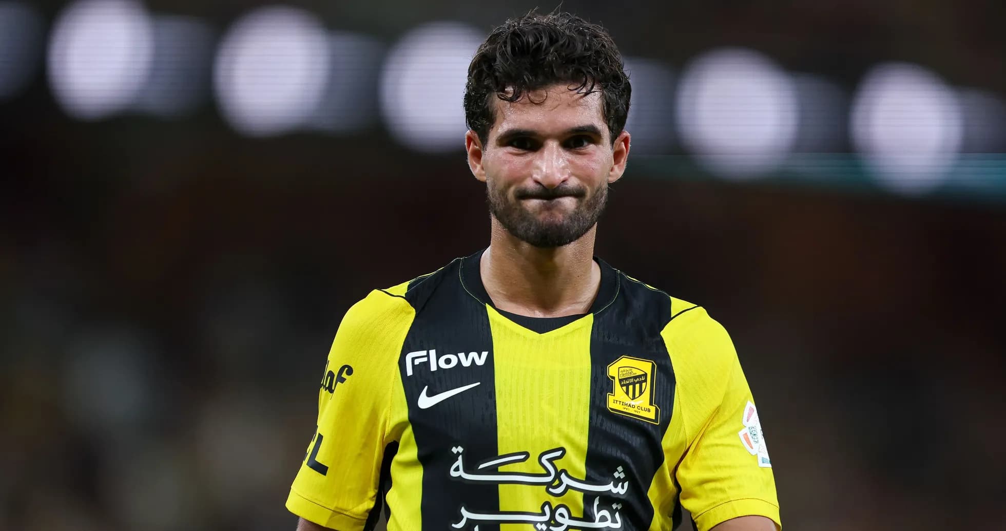 Player in yellow and black jersey on field