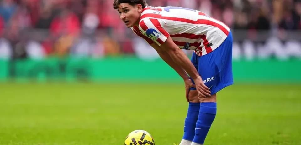 Player preparing to take a free kick on field