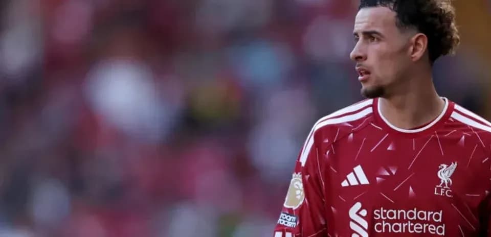 Player in Liverpool jersey on the pitch