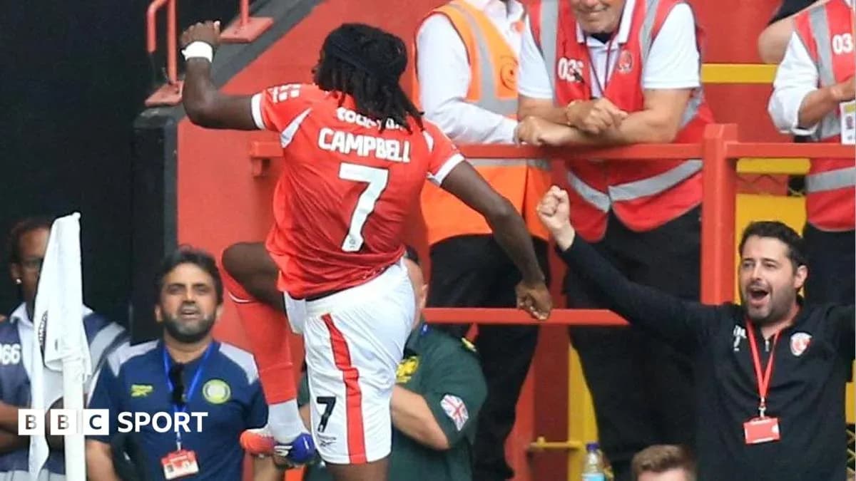 Player celebrating with fans after scoring a goal