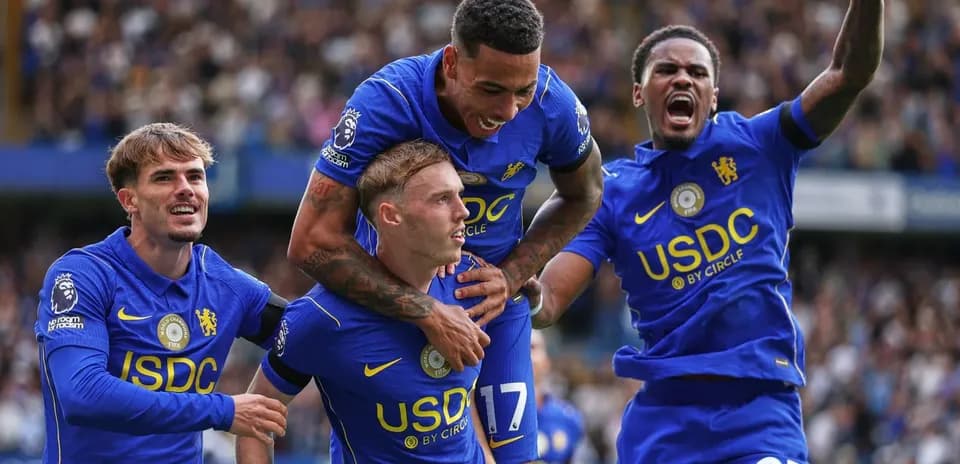 Chelsea players celebrating a goal on the pitch