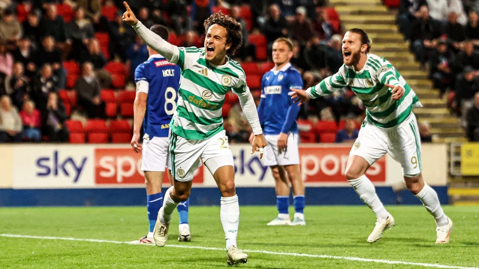 Celtic players celebrating a goal on the pitch